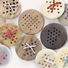 several wooden buttons with different designs on them