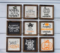 six framed halloween sayings are hung on the wall in front of a wooden frame