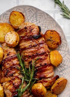 a white plate topped with meat and potatoes