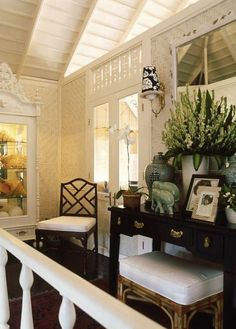 an instagram photo of a living room with furniture and flowers on the top shelf