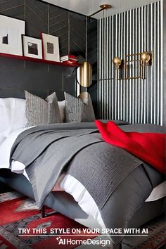 a bedroom with black and white stripes on the wall, gray bedding and red pillows