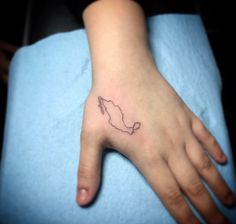 a small map tattoo on the left hand