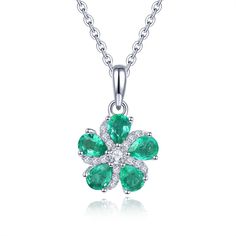 Our Dainty Floral Gemstone Necklace, a charming piece that captures the beauty of nature.  Crafted with care, this pendant features five pear-cut emeralds delicately arranged in the shape of a tiny flower, surrounding a sparkling round white zircon stone at its center.  The pendant is elegantly set within a round silver frame, with a unique starfish-shaped silver frame adding a touch of whimsy and adorned with dazzling white zircon stones.  The rich deep green of the Zambian emeralds adds a sens Elegant May Birthstone Necklace With Flower Shape, Elegant May Birthstone Necklace In Flower Shape, Elegant Flower-shaped Necklace With May Birthstone, Elegant Flower Shaped Necklace With May Birthstone, Elegant Flower-shaped May Birthstone Necklace, Green Flower Pendant Necklace For Anniversary, Elegant Green Pendant Flower Necklace, Pendant For Women, Floral Pendant