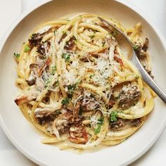 a white bowl filled with pasta and mushrooms