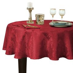 a red table cloth with two candles on it