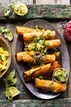 some food is sitting on a plate next to a bowl of fruit and sauces