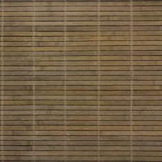 an animal standing on top of a wooden floor next to a wall with vertical blinds