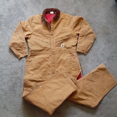 Carhartt Brown Duck Quilted/Insulated Zip Up Coverall X01 Brn Mens Size 48r Euc Pre Owned/Pre Worn Excellent Used Condition. No Tags. Zip Up/Snap Closure On Front And Side Legs. Corduroy Collar. Coveralls Accept Detachable Snap On Hood. ( Not Provided) All Snaps And Zippers Functional. Photos # 5, 6 And 7 ( Show Slight Stain/Paint From Use.) Measures Approx: 29" Inseam X Shoulder Width 20" X Pit Width 25" Rise(Waist To Inseam 15" X Shoulder To Inseam 36". Perfect Coveralls For The Cold Weather S Long Sleeve Overalls With Pockets For Outdoor, Cotton Long Sleeve Overalls For Winter, Winter Workwear Overalls With Pockets, Fitted Winter Overalls With Pockets, Long Sleeve Overalls For Winter Workwear, Carhartt Jackets, Weather Seasons, Men Carhartt, Snap Closure