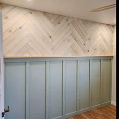 an empty room with wood paneling on the wall