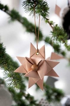 an origami star hanging from a christmas tree