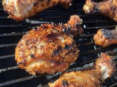 chicken wings are cooking on the grill