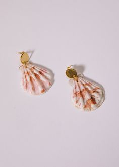 Bring a touch of seaside charm to any outfit with these gorgeous natural shell earrings. Perfect for summer events, these scalloped shell earrings are sure to make a lasting impression. Please note: shells are natural and may vary in color and size. Summer Gift Shell-shaped Earrings, Elegant Shell-shaped Earrings For Vacation, Summer Ocean-inspired Shell-shaped Earrings, Shell-shaped Pearl Drop Earrings, Beachy Shell Dangle Earrings, Summer Shell-shaped Earrings With Ear Wire, Vacation Shell-shaped Earrings With Ear Wire, Ocean-inspired Shell Earrings For Gifts, Shell-shaped Shell Earrings With Ear Wire