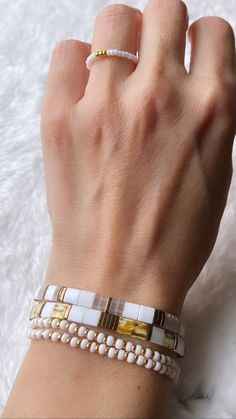 a woman's hand with two bracelets on it