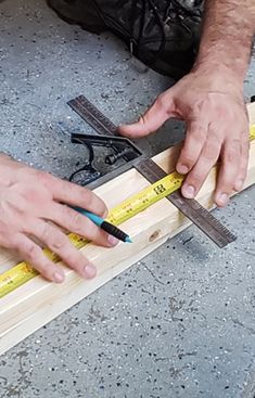 a man is measuring the width of a piece of wood