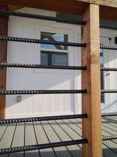 a close up of a wooden fence near a door with a white door in the background