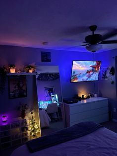 a bedroom with purple lighting and a flat screen tv mounted to the side of the wall