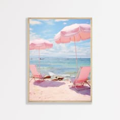 two pink beach chairs under umbrellas on the beach