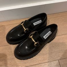 Brand New. Black Leather With Gold Detailing. Black Platform Loafers With Metal Feet For Business, Black Classic Loafers With Metal Pin Buckle, Classic Black Loafers With Metal Pin Buckle, Black Loafers With Metal Pin Buckle For Fall, Black Loafers With Buckle Closure And Almond Toe, Black Slip-on Loafers With Buckle Closure, Black Almond Toe Loafers With Buckle Closure, Black Platform Loafers With Brogue Detailing For Office, Black Brogue Detailed Platform Loafers For Business Casual