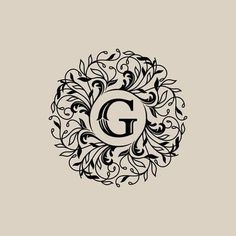 the letter g is surrounded by swirly vines and leaves, as well as an elegant monogram