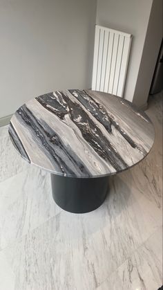 an oval marble table with black and white accents