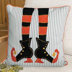 a decorative pillow with legs and boots on it