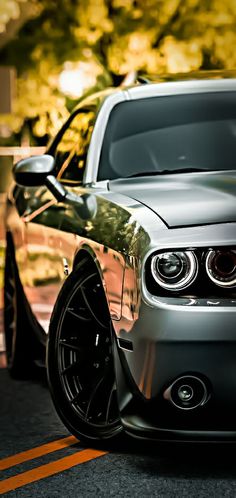 a silver car is parked on the street