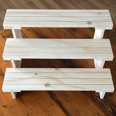 two wooden benches sitting on top of a hard wood floor