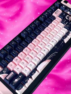 a pink and black computer keyboard on a purple background