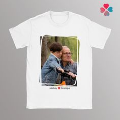 "Custom Photo Print on a T-shirt. A classic unisex t-shirt that works well with any outfit. Made of a heavier cotton with a double-stitched neckline and sleeves. An extra comfy t-shirt that fits perfectly on both men and women. * Rolled-forward shoulders for a better fit * Stylish fitted sleeve * Seamless double-needle collar * Taped neck and shoulders for durability * Tubular fit for minimal torque ------------------------------------------- PRODUCT DETAILS ------------------------------------------- - Solid colors are 100% ring-spun cotton - Heather colors are 65% polyester, 35% ring-spung cotton - Fiber content may vary by color ------------------------------------------- SIZE & HOW TO MEASURE ------------------------------------------- S - Length: 27\" and Half Chest: 18\" M - Length: Casual Sublimation Print T-shirt For Father's Day, Casual T-shirt With Sublimation Print For Father's Day, Father's Day White T-shirt With Custom Print, Unisex Customizable White T-shirt, Unisex Crew Neck T-shirt For Father's Day, Father's Day Unisex Crew Neck T-shirt, Unisex White T-shirt As A Gift, Father's Day White Relaxed Fit T-shirt, Father's Day Graphic Tee With Custom Print