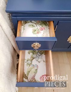 a blue dresser with drawers on top of it