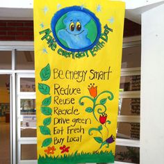 a yellow sign that says be energy smart and features images of the earth on it