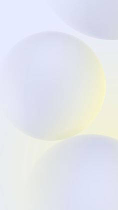 an abstract image of white circles on a light blue and yellow background that is slightly blurry