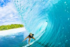 a woman riding a wave on top of a surfboard in the ocean with words above her