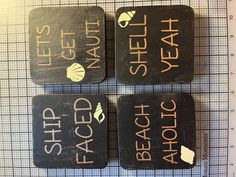 three black coasters with white writing on them