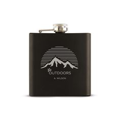 a black flask with the words outdoorss on it and mountains in the background