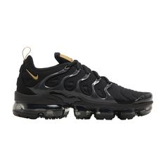 Find NIKE Air Vapormax Plus ' Metallic Gold on Editorialist. An all-black release that channels two Nike legacies in one, the Nike VaporMax Plus sneaker combines the wavy cage upper of the Nike Air Max Plus sneaker with the instantly recognizable cushioning unit of the Nike VaporMax shoe. This 'Black Metallic Gold' version features a blacked-out palette with a touch of metallic gold at the Swoosh, tongue and pull tab. Underfoot, a transparent VaporMax sole unit complements this ultra-sleek design. Black Basketball Shoes With Translucent Outsole, Black Sneakers With Translucent Outsole For Sports, Streetwear Sneakers With Air Cushioning, Lace-up Running Shoes With Air Cushioning For Streetwear, Nike Air Max Lace-up With Boost Midsole For Streetwear, Functional Nike Air Max For Streetwear, Nike Black Athleisure Basketball Shoes, Nike Air Max With Cushioned Footbed For Streetwear, Functional Nike Air Max With Cushioned Footbed For Streetwear