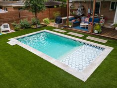 a small backyard with a pool and decking in the grass, surrounded by lawn furniture