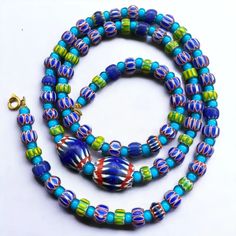 a multicolored beaded necklace with gold clasp