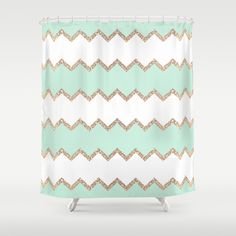 a green and white shower curtain with an ornate pattern on it's side, in the style of zigzag