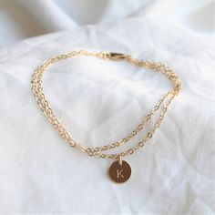 Our Double Chain Bracelet comes in silver, rose or gold chain options. Two sparkling chains for a minimal and chic look for everyday. Adorned with a tiny initial disc for that extra special touch.  Makes the perfect gift too!_______________________________________D E T A I L S--Two layers of dainty link chain-8mm initial disc. -High quality 14kt gold filled, rose filled or sterling silver - not plated.-Premium lobster claspLENGTH- Please select from the drop down selection.- Fits most sizing:6.0 Double Chain Bracelet, Layered Bracelet, Jewelry Dainty, Personalized Bracelet, Dainty Bracelet, Initial Bracelet, Double Chain, Dainty Bracelets, Personalized Bracelets