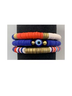 Gorgeous bracelet stack.  Stack comes with three bracelets made of of vibrant dark blue, red and pale pink mix with gold disc Heishi metal accent discs.  Perfect stack to add a good pop of color to your outfit. Adjustable Stacked Blue Bracelets, Multicolor Stacked Bracelets For Beach, Red Stacked Beaded Bracelets For Gifts, Red Stacked Beaded Bracelets As Gift, Adjustable Red Stacked Beaded Bracelets, Adjustable Stacked Red Beaded Bracelets, Blue Stacked Beaded Bracelets, Blue Stacked Bracelets With Round Beads, Blue Stackable Heishi Beads Bracelets