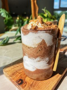 a dessert in a glass on a wooden tray