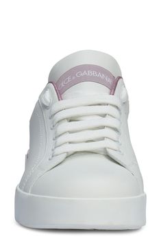 In Dolce&Gabbana's typical glamorous fashion, this low-top leather sneaker stands out with metallic-pink trim. A micro-injected rubber logo at the heel amps up the statement factor. 3/4" platform (size 38.5) Lace-up style Removable insole Leather upper and lining/synthetic sole Made in Italy Salon Shoes White Platform Sneakers With Embossed Logo, Luxury Pink Platform Sneakers With Contrast Sole, Pink Low-top Platform Sneakers With Cushioned Footbed, Luxury Pink Lace-up Platform Sneakers, Salon Shoes, Luxury White-sole Platform Sneakers In Synthetic, Glamorous Fashion, Pink Trim, Platform Sneaker