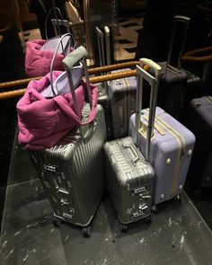 several pieces of luggage are stacked on top of each other in front of a mirror