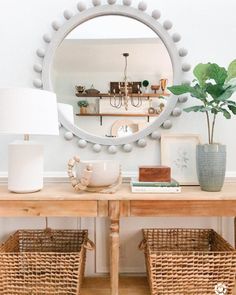 a table with baskets and a mirror on it