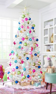 a white christmas tree decorated with colorful ornaments