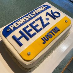 a cake that has been decorated with the name of pennsylvania heez on it's side