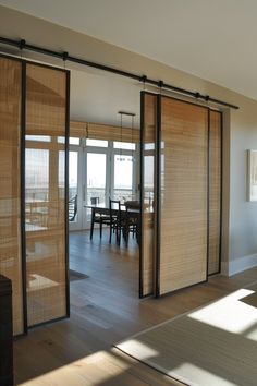 an open living room with sliding doors leading to the dining room