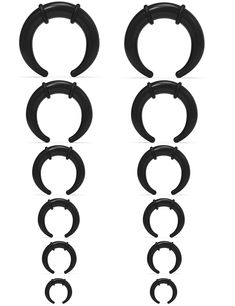 four pairs of black plastic hoops on a white background