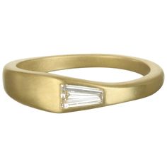 Modern and minimalistic. You could say "I do" with this 18k gold* diamond ring. Or, you could make a stack and elevate your own unique style. The unexpected diamond baguette shines brightly against the gold matte finish. There is beauty in simplicity! Size 7.25 Diamond: .25 Carats Ring is handmade and may appear slightly different than rings in photos. Ring in the second photo is the actual ring. Other rings sold separately. Made in the USA *In Faye Kim's signature 18k green gold, an alloy compr Modern Rings With Baguette Diamonds, Modern Baguette Diamond Ring In Yellow Gold, Modern Yellow Gold Baguette Ring, Modern Rectangular Baguette Diamond Ring, Modern Baguette Yellow Gold Rings, Modern Diamond Ring With Baguette Diamonds As A Gift, Modern Diamond Baguette Rings, Modern Baguette Gold Rings, Minimalist Baguette Cut Diamond Ring With Rose Cut